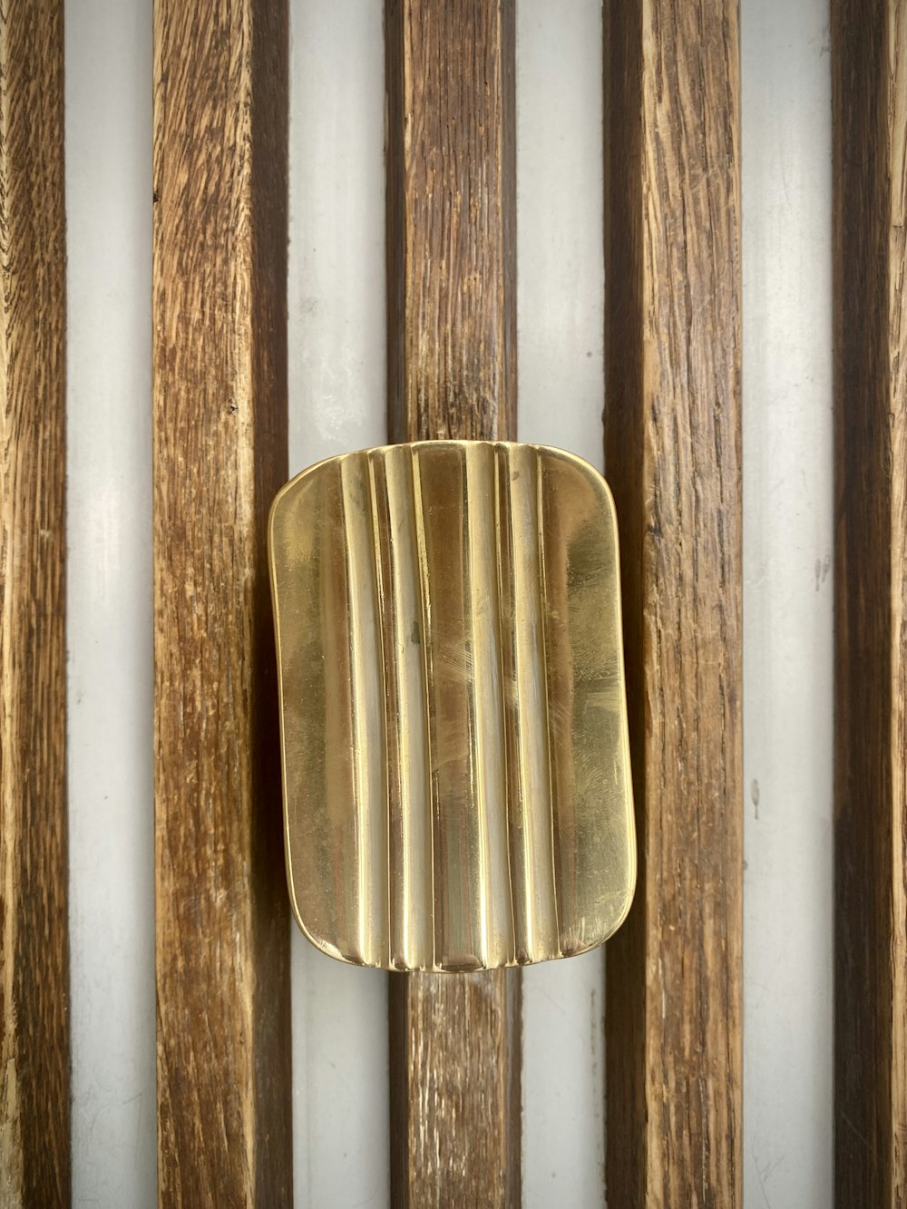 Photo: Arno Senoner · Unsplash Solid brass soap dish on a stone wall holding a bar of soap